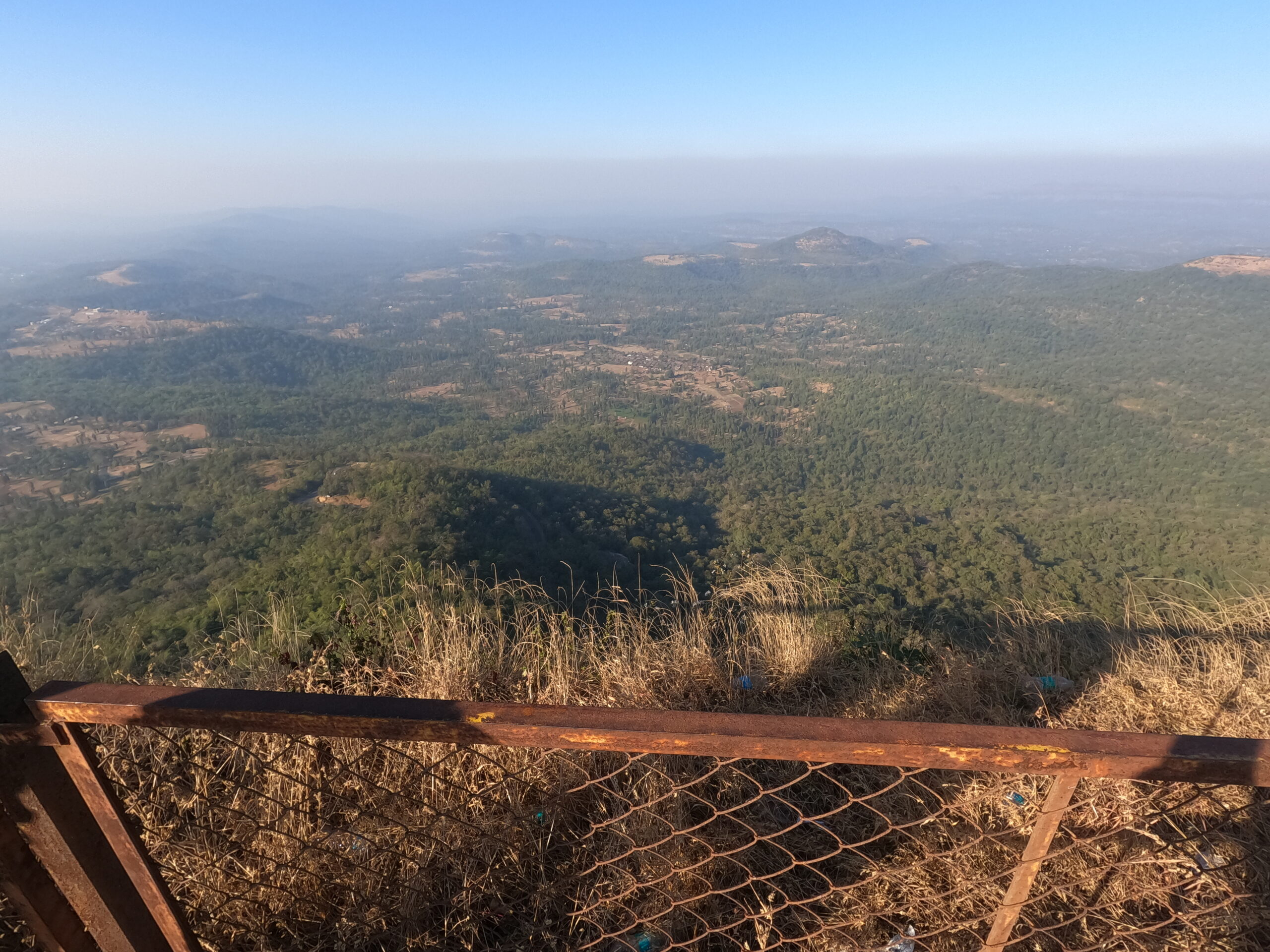 Overlooking the Canopy: A Vast, Hazy Mountain Vista